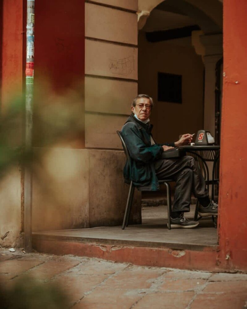 man in black jacket sitting on black chair